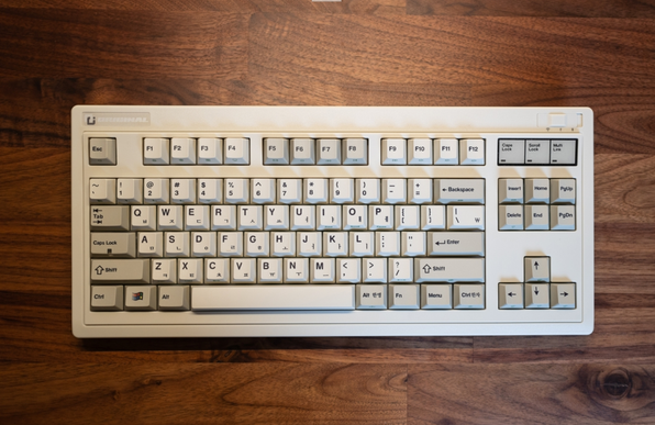 Retro looking keyboard on a dark wooden background