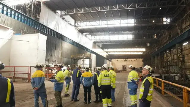 Tata Steel leaders stand inside Port Talbot steelworks, viewing the large empty space prepared for the new pickle line project.