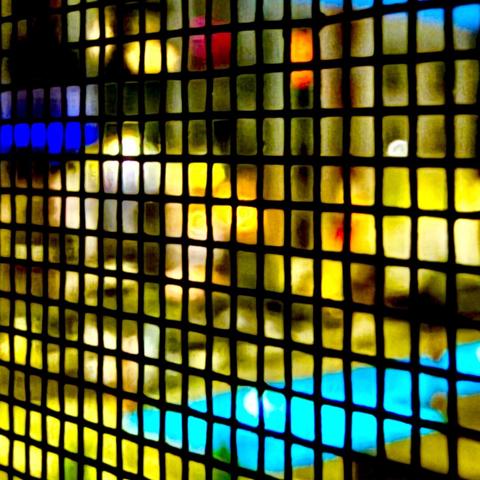 Abstract image of an apartment courtyard pool at night as seen through a screen in a window.