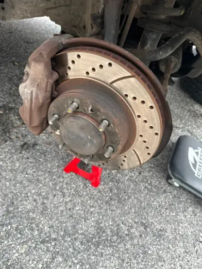 Slotted and drilled brake rotors on a Toyota FJ Cruiser.