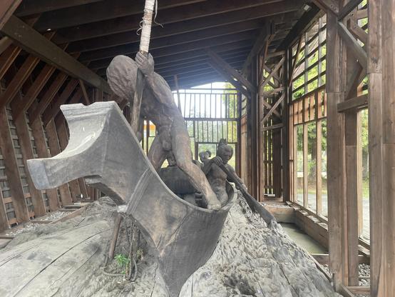 The Whaling sculpture is of :TseshahtFN: hunters. Their territory extends down the Alberni Inlet while Hupacasath is in the Valley. there is a figure holding a large harpoon at the head of the canoe while other figures paddle behind. The whole thing is carved from a large douglas fir log