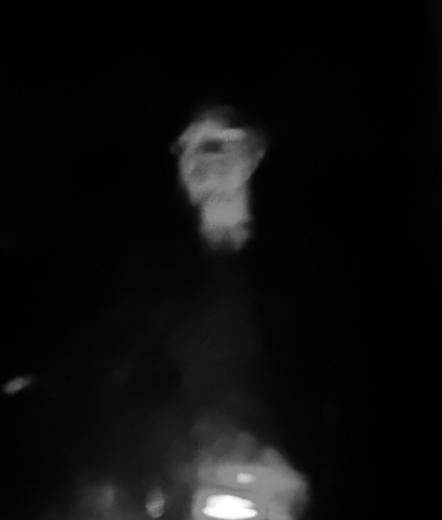A heavily distorted, blurry, black-and-white photo of myself looking at the camera. The right side of my face and body seems to be drooping.