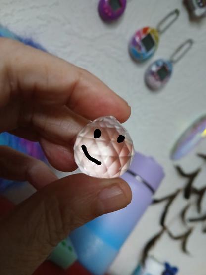 a glass prism thing with a digital drawn face