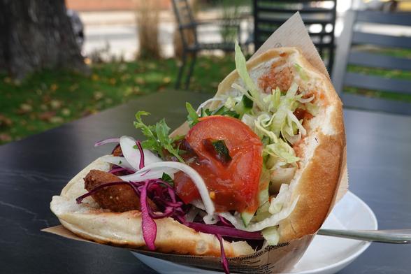 besagter Döner auf einem Tisch im Garten eines Schnellrestaurants