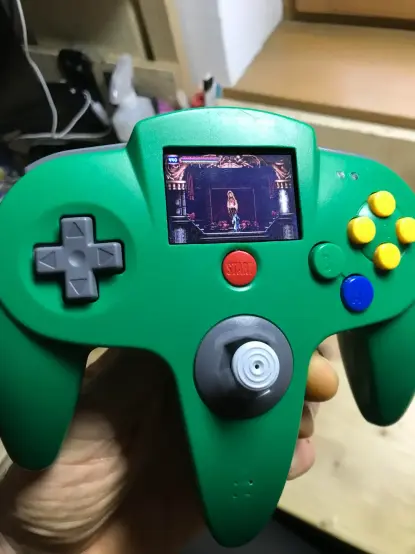 Image from the link showing a Game Boy Micro with Castlevania on it, inside of a green N64 controller
