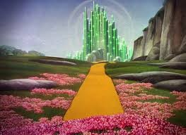 The 1930s movie version Emerald City seen in the distance, with the yellow brick road leading straight to it.
