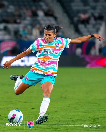 Kenza Dali goes to kick a ball during the match.