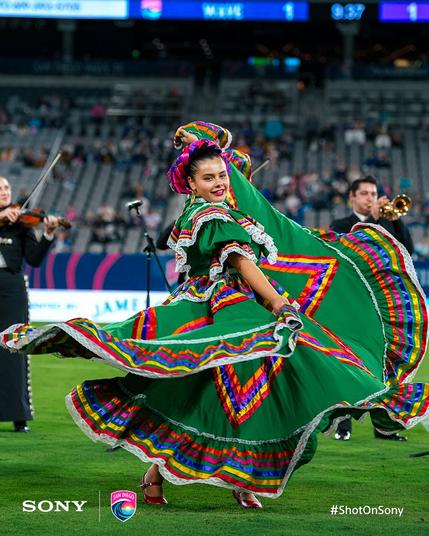 A dancer dances during the halftime perforamce at Snapdragon Stadium.
