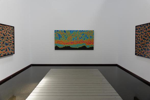 an exhibition of paintings in a gallery
