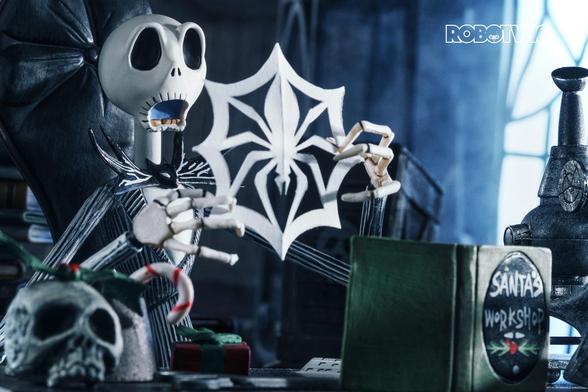 Jack Skellington in his lab tries to make a paper snowflake ❄️ using a book called Santas Workshop on his desk, he unfolds it and the snowflake is a spider in a web, he looks shocked
