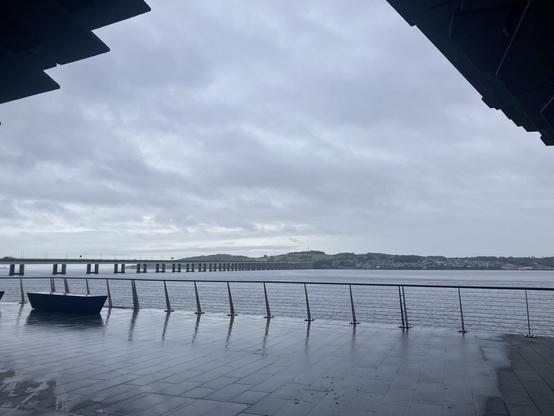 View of the Tay Firth towards the vehicle bridge from under the arch of the V and A museum Dundee on a grey drizzling morning