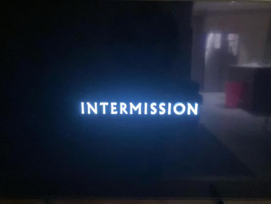 A blurry photo of my TV with the word INTERMISSION on it.