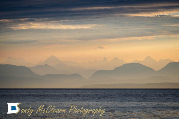Hazy mountains in the orange light of dawn.