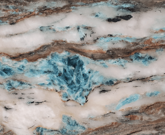 A closeup of a stone countertop with the blue mineral kyanite:
https://primestones.com/blogs/kyanite-a-blue-gem/