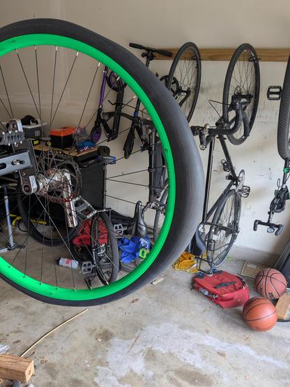 An 29" tube inflated and stretched onto a green 36" unicycle rim. There's a mildly alarming bulge on one end.