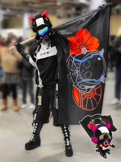 Me in a drone form, covered from head to toes mostly in black, white and silver. I'm in a cyber black and white coat with short, baggy pants with reflective straps and chains, stompy high goth patent boots and black long gloves. My face is covered with a gas mask with a screen showing the non-binary flag, hoses and a LED ring. I'm wearing a pair of red glowing cat headphones. I'm also holding a black pirate personal flag with a cyber helmet, a cherry blossom and a train wheel in red. The background is blurry but a large hall is distinguishable with some people passing by behind me.

In the lower right corner of the picture there's a chibi version of me with almost exactly the same attire.