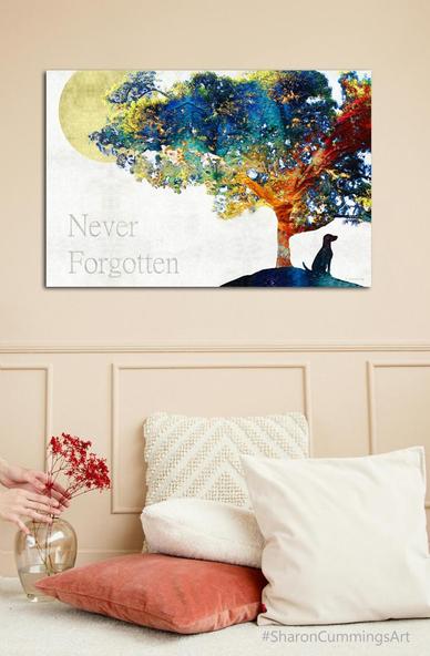 Colorful tree with a dog sitting under it and the words Never Forgotten to the left by artist Sharon Cummings.  In a home decor setting.