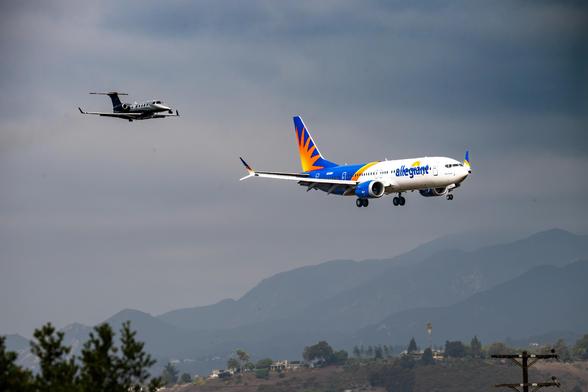 An Allegiant Boeing 737 MAX 8-200 being closely followed by an Embraer Phenom camera ship on approach to the Santa Barbara Airport.