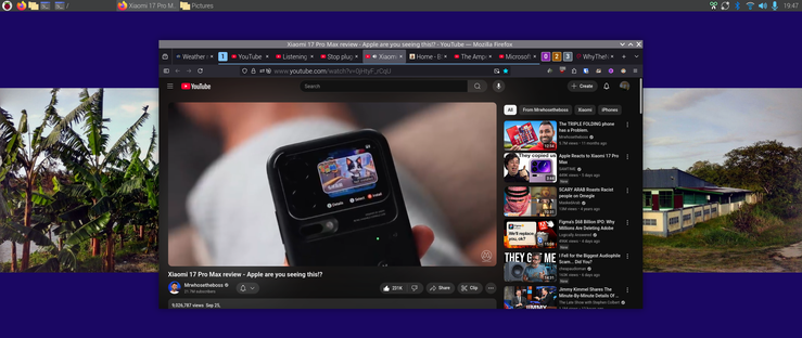 The image shows a computer screen with a YouTube video open in the center. 
Rear display gaming cover and experience is accentuated here
The video is titled "Xiaomi 17 Pro Max review - Apple are you seeing this?" and features a man sitting on a couch holding two smartphones, with a "Snapdragon 8 Elite" logo visible. The video is labeled "PERFORMANCE" and has a timestamp of 21:16. The YouTube interface includes a search bar, a video player, and a sidebar with related videos. The sidebar features titles such as "The Triple Folding phone," "Apple Reacts to Xiaomi 17 Pro," and "WhyTheHell." The background of the screen shows a split view with images on the left and right sides: on the left, there is a picture of banana trees, and on the right, there is a picture of a house with a blue roof and a white fence. The browser tabs at the top include "Xiaomi 17 Pro Max review," "Weather," "Listening," "Stop," "Apple," and "Xiaomi." The time displayed in the top right corner is 19:39.

Provided by @altbot, generated privately and locally using Ovis2-8B

🌱 Energy used: 3.223 Wh
