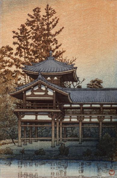Dusk falls at the the Phoenix Hall, part of the Byodo-in Temple in Uji, Kyoto Prefecture. In the foreground, the surface of the Aji-ike pond is still and calm; just beyond, one wing of the Phoenix Hall stands backed by tall trees, their leaves turning colour with the season. No people are visible, and everything seems peaceful and quiet. Above, the sky glows burnt orange and coral, with deeper evening beginning to colour the horizon.