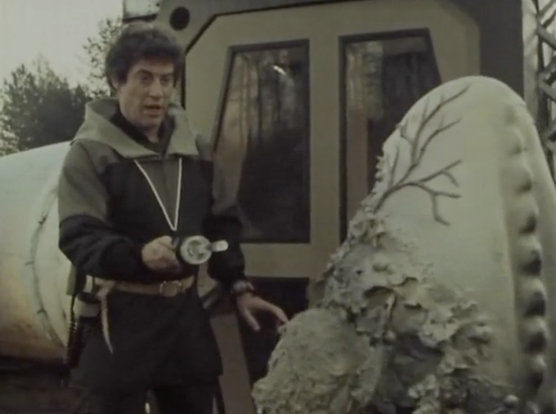 Blake points his laser gun at the alien