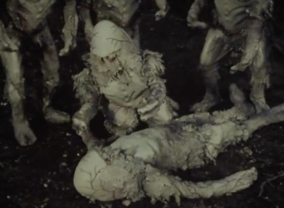 The alien lies dead on the ground, surrounded by other related aliens