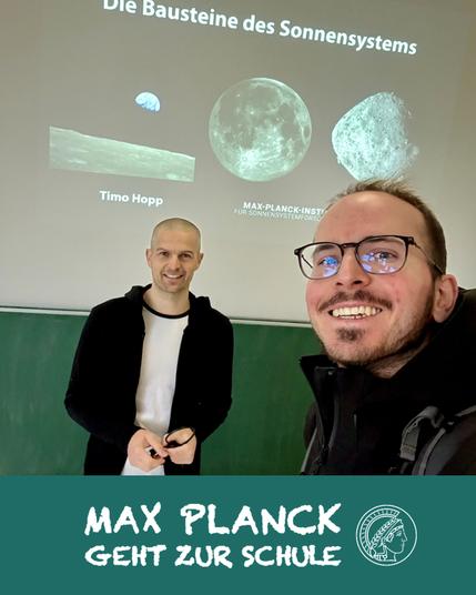 two scientists in front of a blackboard