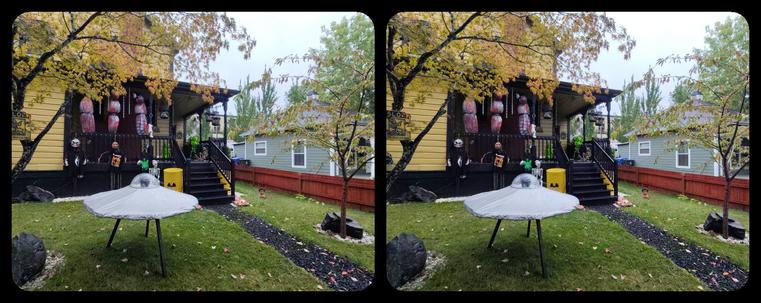 An alien invasion Halloween yard display in front of a suburban house. I don't really approve of the body bag thing, but whatever. Stereoscopic.
