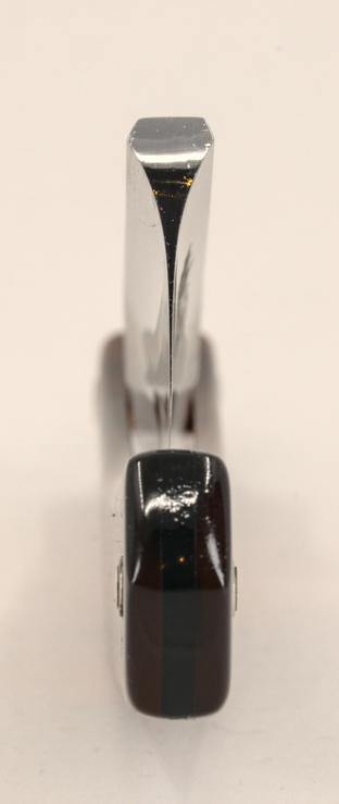 (Le Chat Mistral description)

This image shows a close-up view of the pivot area of a straight razor. The razor's blade is folded into its tortoiseshell-patterned handle, which features dark brown and black tones. The visible portion of the blade is metallic and polished, tapering to a sharp point at the pivot. The handle appears to be made of a layered material, giving it a sleek and elegant look. The focus is on the junction where the blade meets the handle, highlighting the razor's craftsmanship and design.