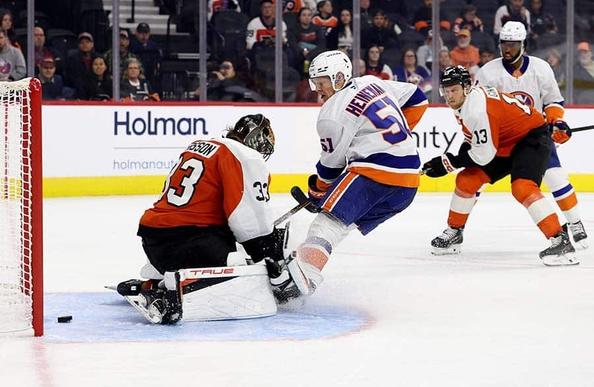 PHILADELPHIA, PENNSYLVANIA - OCTOBER 02: Emil Heineman #51 of the New York Islanders scores a goal past Samuel Ersson #33 of the Philadelphia Flyers during the third-period of a preseason game at Xfinity Mobile Arena on October 02, 2025 in Philadelphia, Pennsylvania.