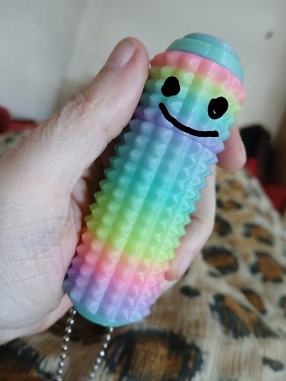 a little ouchies stimtoy with a face doodle