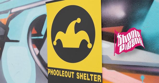 A sign for the PhooleOut Shelter is posted over a brightly-colored graffiti mural. The fuchsia Phoole and the Gang flag floats beside it.