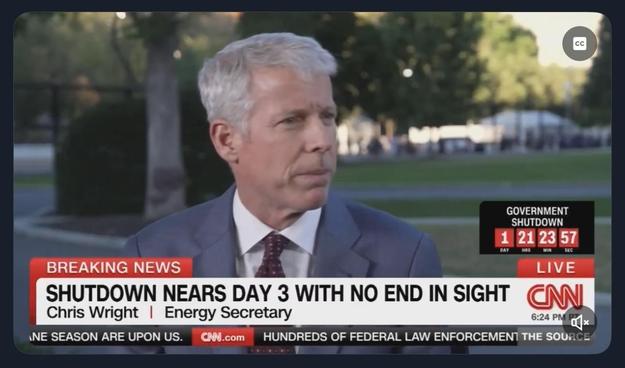 Image features a man, identified as Chris Wright, the Energy Secretary, speaking on CNN amidst a news segment about an ongoing government shutdown. The screen displays a countdown timer and the text "SHUTDOWN NEARS DAY 3 WITH NO END IN…