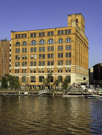 Photo of a historic building made of yellow bricks in golden-hour light