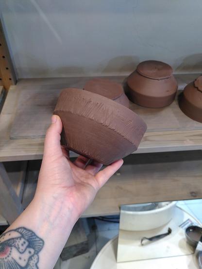 Bol en terre crue fraîchement tournassé
Il est tenu en main par la potière
