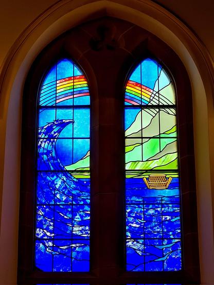 A modern stained glass window in a Victorian church.