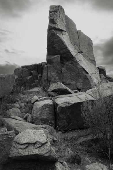 A chiselled rock outcropping before moody skies.