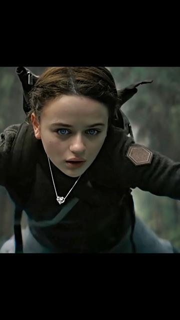 A shot from the Netflix movie Uglies of Joey King hovering inches from the ground after plummeting from a cliff. She wears Xover0's silver heart shaped necklace around her neck. This original design is integral to the plot and part of her character Tally's costume.