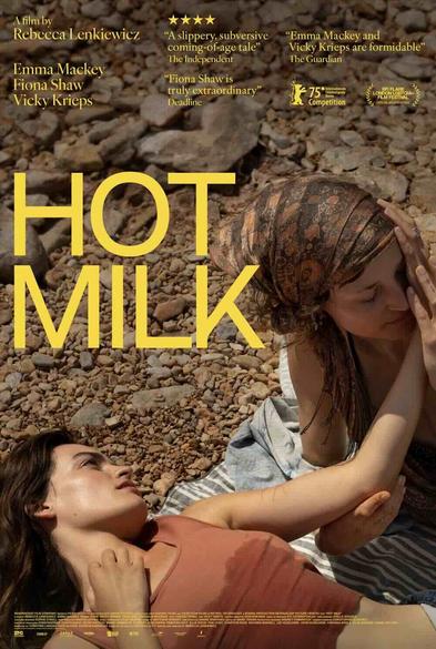 The poster for Hot Milk shows Emma Mackey and Vicky Krieps embracing on a rocky beach.