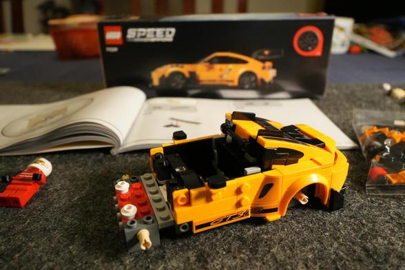 A partially done yellow Lego Porsche 911 GT3 RS.