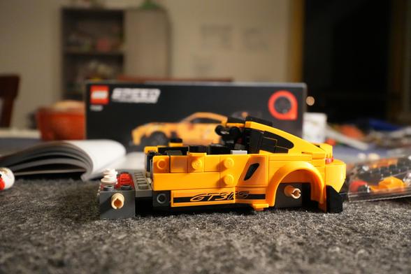 A partially done yellow Lego Porsche 911 GT3 RS.