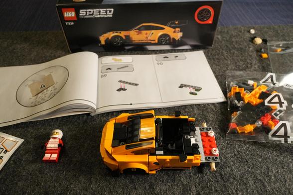 A partially done yellow Lego Porsche 911 GT3 RS.