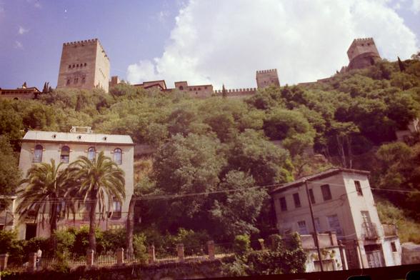 Looking up a wooded hill, to a fortress