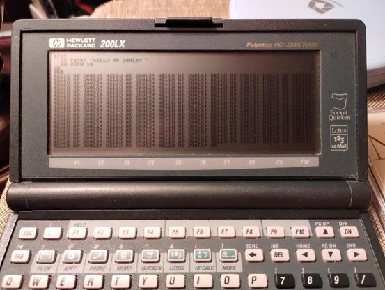 Palmtop PC repeatedly displaying HELLO HP 200LX! on the screen from a BASIC prompt.
