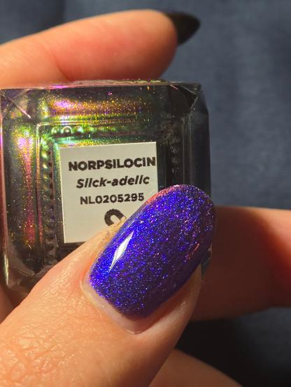 My thumb on the tag of the nail polish bottle