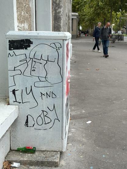 a market drawing on the side of a streetside utility box of a girl with a sharp fringe giving the side-eye and the outline of what looks like a dog or other canid, in simple, stylised lines, accompanied with the caption “ILY AND DOBY”