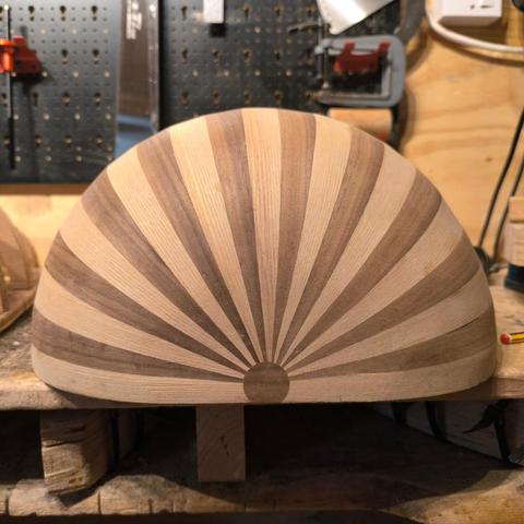 The body of an oud I'm building, viewed from the end with an inlaid circle where the ribs meet.