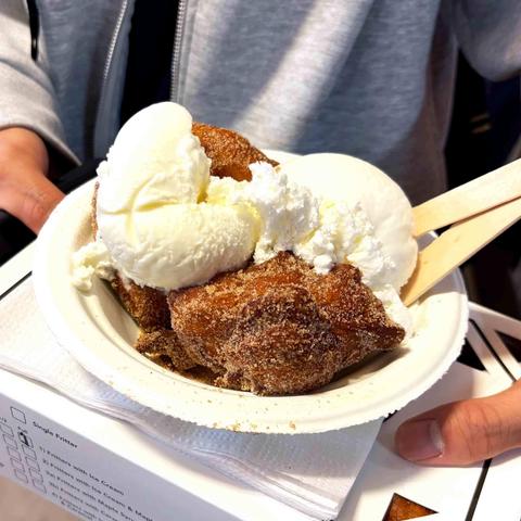 A bowl of ring style apple fritters with vanilla ice cream, from St Jacobs Market's The Fritter Co.