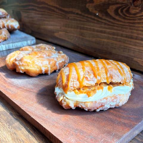 A doughnut-style apple fitter and one that's stuffed with cheesecake cream and apple compote, and drizzled with caramel, from Impressions Bakery in St Jacobs