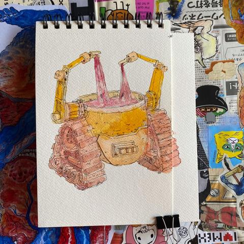 Ilustracion en acuarela en color amarillo de un robot con una llantas como de tanque, el cuerpo del robot es un vaso con una sustancia pastosa y el robot tiene dos manos que jalan dicho líqudo para arriba. El dibujo está en un cuaderno con un pedazo de papel juntado con una pinza para completar el dibujo